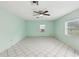 Spacious living area boasts tile floors, multiple windows, and a ceiling fan at 13241 Miami St, Hudson, FL 34667