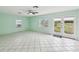 Spacious living area boasts tile floors, multiple windows, and a glass door leading outside at 13241 Miami St, Hudson, FL 34667