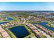 Expansive aerial view showcasing a community with stunning ponds and a meticulously maintained golf course at 135 Sweet Tree St, Bradenton, FL 34212