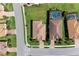 Overhead view showcasing well-maintained homes with tiled roofs, manicured lawns, and private pools in a serene neighborhood setting at 135 Sweet Tree St, Bradenton, FL 34212