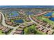 Panoramic aerial perspective showcasing a residential area with lakes, a golf course, and beautiful homes with tiled roofs at 135 Sweet Tree St, Bradenton, FL 34212