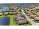Aerial view of a residential community with serene lakes, well-maintained streets, and beautiful tiled-roof homes at 135 Sweet Tree St, Bradenton, FL 34212