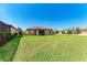 Expansive backyard with lush green lawn perfect for outdoor activities and enjoying the serene surroundings at 135 Sweet Tree St, Bradenton, FL 34212