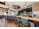 Stylish bar area featuring a marble countertop, pendant lighting, and comfortable seating at 135 Sweet Tree St, Bradenton, FL 34212