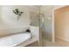 Bright bathroom features a soaking tub and frameless glass shower at 135 Sweet Tree St, Bradenton, FL 34212