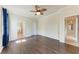 Spacious bedroom with dark wood floors, ceiling fan, and ensuite bathroom at 135 Sweet Tree St, Bradenton, FL 34212