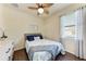 Bedroom featuring a ceiling fan and a bed with blue accents, creating a relaxing space at 135 Sweet Tree St, Bradenton, FL 34212
