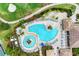 High angle aerial view of a uniquely shaped pool with lounge chairs in a gorgeous community setting at 135 Sweet Tree St, Bradenton, FL 34212