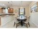 Charming dining area with a round table, seating for four, and views of the kitchen and backyard at 135 Sweet Tree St, Bradenton, FL 34212