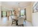 Bright dining area features a wooden table, upholstered chairs, and a decorative chandelier at 135 Sweet Tree St, Bradenton, FL 34212