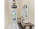 Inviting entryway with decorative mirror and console table, creating a stylish and welcoming atmosphere at 135 Sweet Tree St, Bradenton, FL 34212