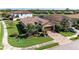 Beautiful single-story home with a tile roof, brick driveway, and meticulously manicured landscaping at 135 Sweet Tree St, Bradenton, FL 34212