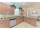 Kitchen with granite countertops, stainless steel appliances, wooden cabinetry, and views of the dining area at 135 Sweet Tree St, Bradenton, FL 34212