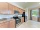 Modern kitchen with stainless steel appliances and granite countertops, perfect for cooking and entertaining at 135 Sweet Tree St, Bradenton, FL 34212