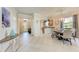 Open-concept space with dining area, kitchen view, and entryway, perfect for modern living and entertaining at 135 Sweet Tree St, Bradenton, FL 34212