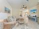 Bright living room featuring tile floors, comfortable seating, and a view into the kitchen and dining area at 135 Sweet Tree St, Bradenton, FL 34212