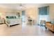 Bright bedroom featuring tile floors, a decorative ceiling fan, and a comfortable king-size bed at 142 Dory Ln, Osprey, FL 34229