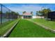 Bocce ball court with manicured landscaping and a covered patio area at 142 Dory Ln, Osprey, FL 34229
