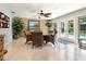 An ample dining room with a large table and chairs sits beside the pool area at 142 Dory Ln, Osprey, FL 34229