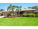 Welcoming single-story home featuring mature landscaping, a well manicured lawn, and a neutral color palette at 142 Dory Ln, Osprey, FL 34229