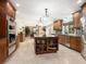 Beautiful kitchen with wood cabinets, a stainless steel refrigerator, an island and open layout into the dining area at 142 Dory Ln, Osprey, FL 34229
