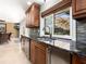 This kitchen features dark wood cabinets, stainless steel appliances, and a granite countertop at 142 Dory Ln, Osprey, FL 34229