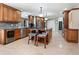 This kitchen features dark wood cabinets, stainless steel appliances, a center island, and tiled floors at 142 Dory Ln, Osprey, FL 34229