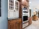 Updated kitchen features stainless steel appliances, wood cabinetry, and modern finishes, showcasing style and functionality at 142 Dory Ln, Osprey, FL 34229
