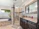 The main bathroom features a glass-enclosed shower, soaking tub, and dual vanity at 142 Dory Ln, Osprey, FL 34229