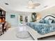 The main bedroom boasts an ensuite desk area and doors leading to the pool at 142 Dory Ln, Osprey, FL 34229