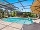 Backyard pool and jacuzzi enclosed by a screened-in lanai, offering privacy and comfort at 142 Dory Ln, Osprey, FL 34229