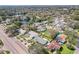 Neighborhood aerial view showcasing mature trees, a nearby lake, and a well-situated neighborhood at 1440 S Keene Rd, Clearwater, FL 33756