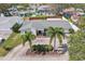 An inviting single-story home featuring a well-kept lawn, attractive landscaping, and a sealed driveway at 1440 S Keene Rd, Clearwater, FL 33756