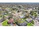 Panoramic aerial view shows the neighborhood layout in a well-treed area with a nearby busy road at 1440 S Keene Rd, Clearwater, FL 33756