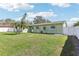Large backyard with green grass and a fenced perimeter at 1440 S Keene Rd, Clearwater, FL 33756