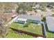 Aerial view of backyard showing fenced yard, landscaping, and charming, single-story home at 1440 S Keene Rd, Clearwater, FL 33756