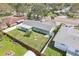 Aerial view of backyard showing fenced yard, landscaping, and charming, single-story home at 1440 S Keene Rd, Clearwater, FL 33756