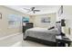 Bedroom with large bed, windows for natural light, and ceiling fan at 1440 S Keene Rd, Clearwater, FL 33756