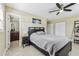 Bedroom featuring a large bed, fan, and adjoining bathroom at 1440 S Keene Rd, Clearwater, FL 33756