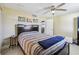 Cozy bedroom featuring tiled floors, ceiling fan, and minimalist decor at 1440 S Keene Rd, Clearwater, FL 33756
