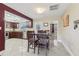 Dining area leading to kitchen featuring tile floors, wood table, and stainless appliances at 1440 S Keene Rd, Clearwater, FL 33756