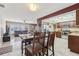 Open dining and kitchen area with tile flooring, wood table and stainless steel appliances at 1440 S Keene Rd, Clearwater, FL 33756
