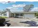 Charming home with a well-maintained lawn, a spacious driveway, and an attached two-car garage at 1440 S Keene Rd, Clearwater, FL 33756