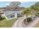 Inviting single-story home with a well-kept lawn, landscaped beds, and a freshly sealed driveway at 1440 S Keene Rd, Clearwater, FL 33756