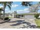 Charming home boasts a well-manicured lawn and a spacious driveway leading to a convenient two-car garage at 1440 S Keene Rd, Clearwater, FL 33756