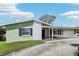Inviting one-story home features a well-kept lawn, brick accents, and a convenient attached two-car garage at 1440 S Keene Rd, Clearwater, FL 33756