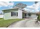 Attractive one-story home featuring a brick facade, lush lawn, and a convenient attached two-car garage at 1440 S Keene Rd, Clearwater, FL 33756