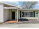 Inviting one-story home features a cozy front porch and well-maintained landscaping at 1440 S Keene Rd, Clearwater, FL 33756