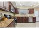 Updated kitchen with granite countertops, stainless steel appliances, and dark wood cabinets at 1440 S Keene Rd, Clearwater, FL 33756