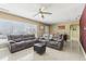 Spacious living room with tile floors, comfortable seating, and ample natural light from a large window at 1440 S Keene Rd, Clearwater, FL 33756